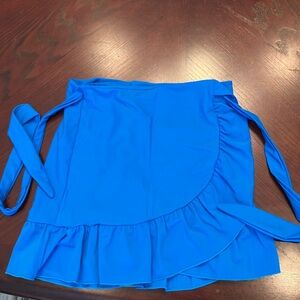 A swim wrap around cover up skirt
